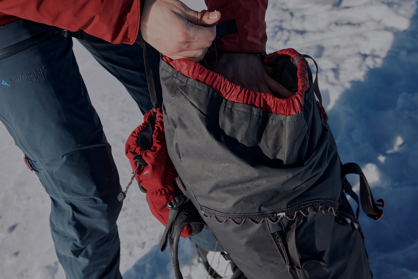 Close-up of backpack being packed in the snow